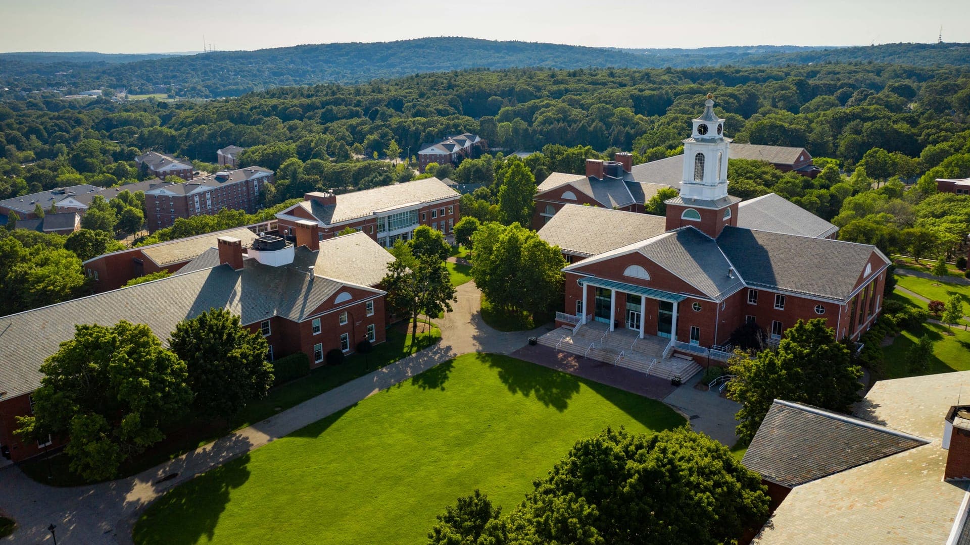 Aerial view of the Bentley University campus in Waltham, brick buildings around the central lawn.