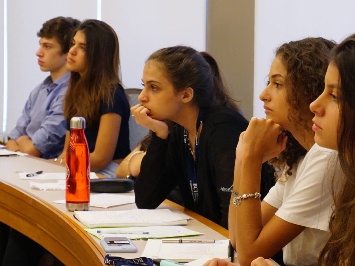Participants leaning into their work in a university classroom.