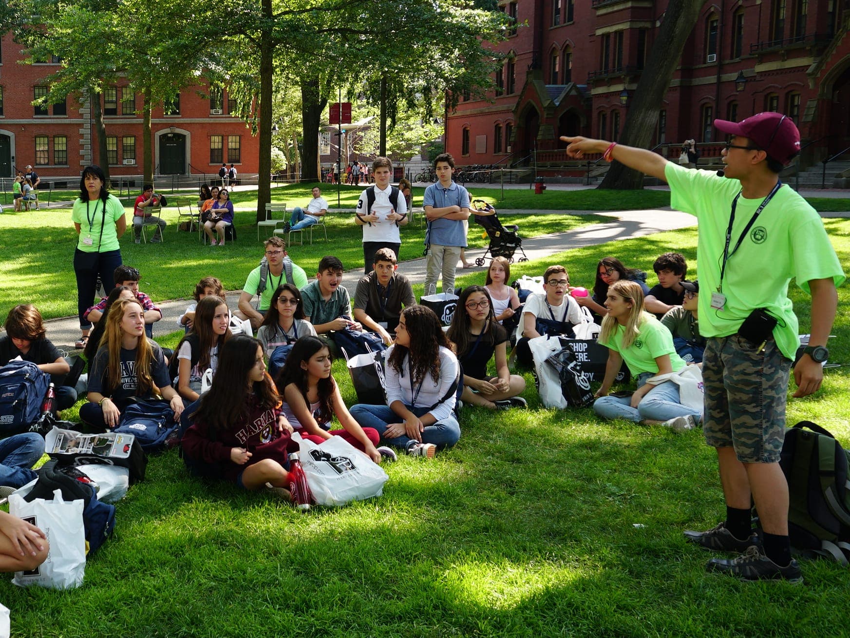 BCI group seated on the Harvard Yard lawn during a guided campus tour.