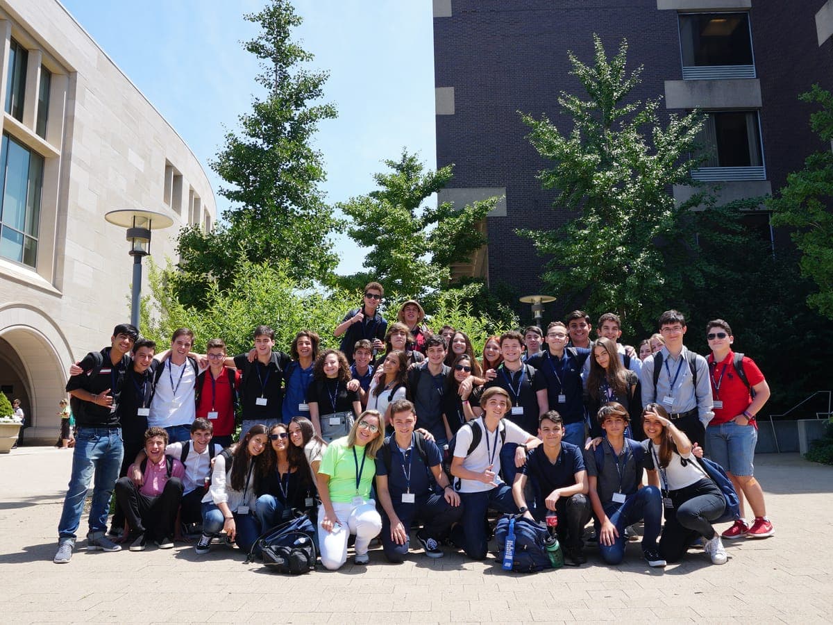 Official group photo of the cohort gathered in a university courtyard in Cambridge.